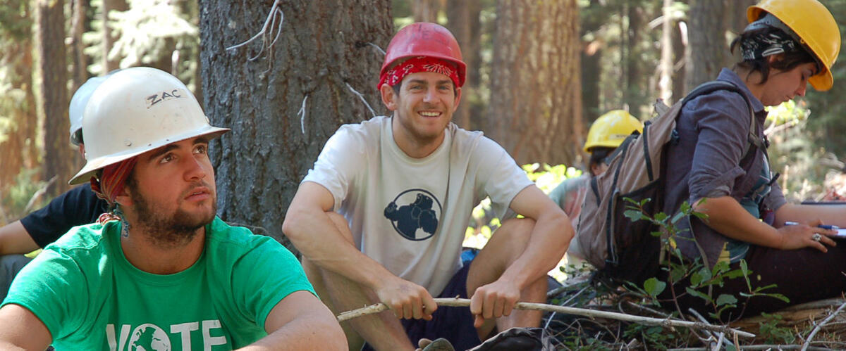 Students in the forest wearing hard hats