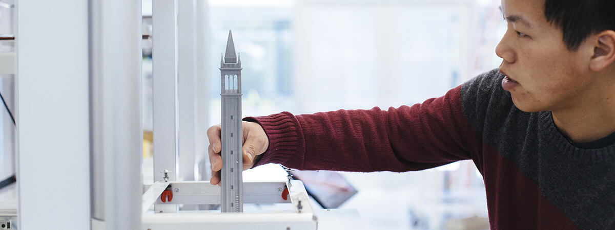 Student working with a model of the Campanile